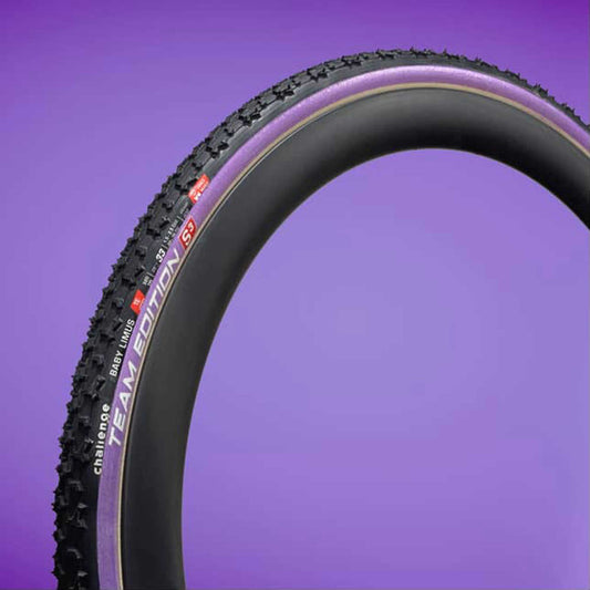 Bicycle tire with visible branding on a purple background